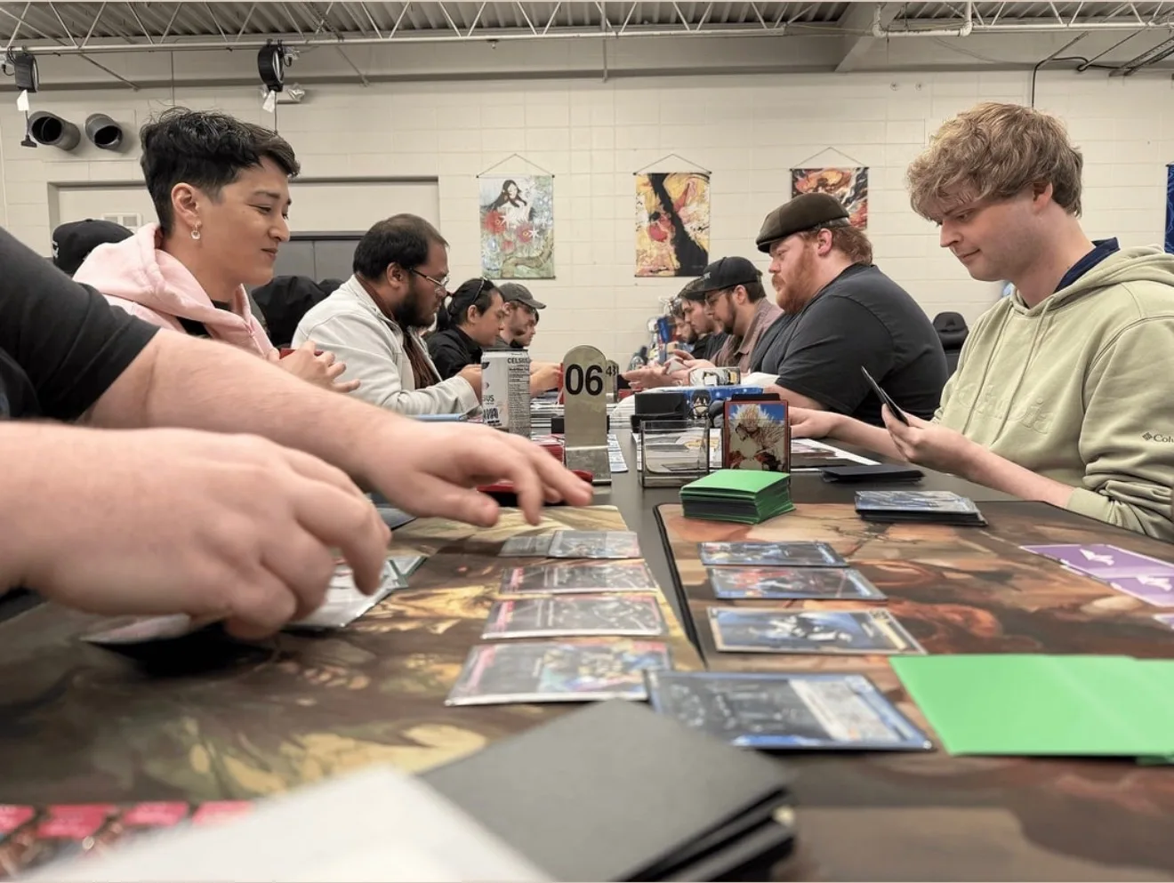 Players face one another across a long table during Gundam trading card matches