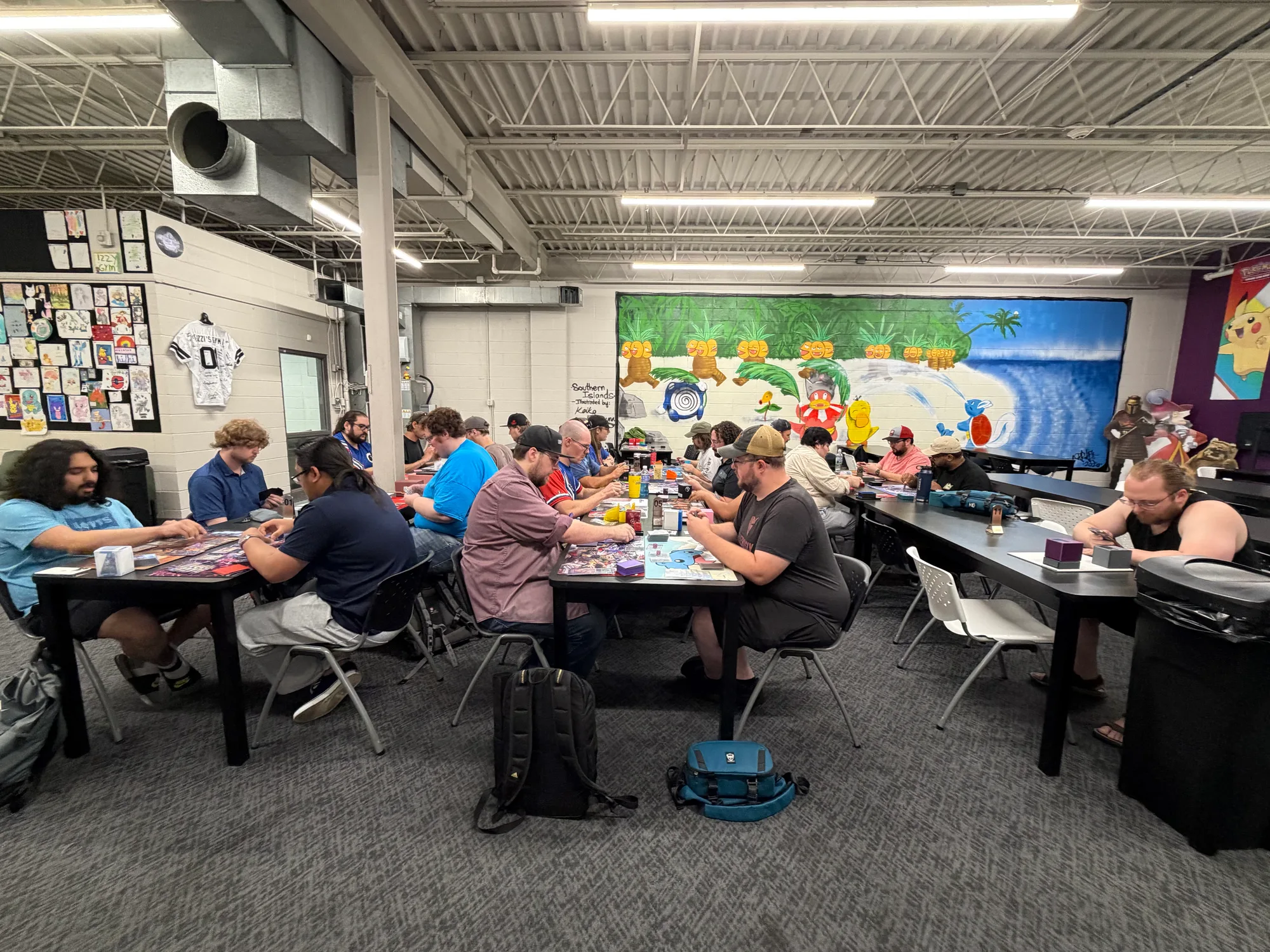 Players fill several tables during a Gundam trading card event at Izzi's Gym