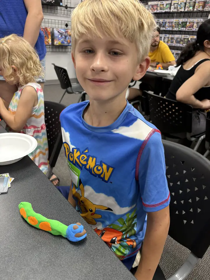 A young guest shows a character they made during a kids activity at Izzi's Gym